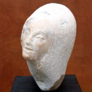 Menschlicher Kopf im kleinen rosa Flusskiesel